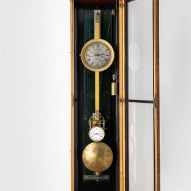 Weight-driven regulator with case opened to reveal pendulum and two dials