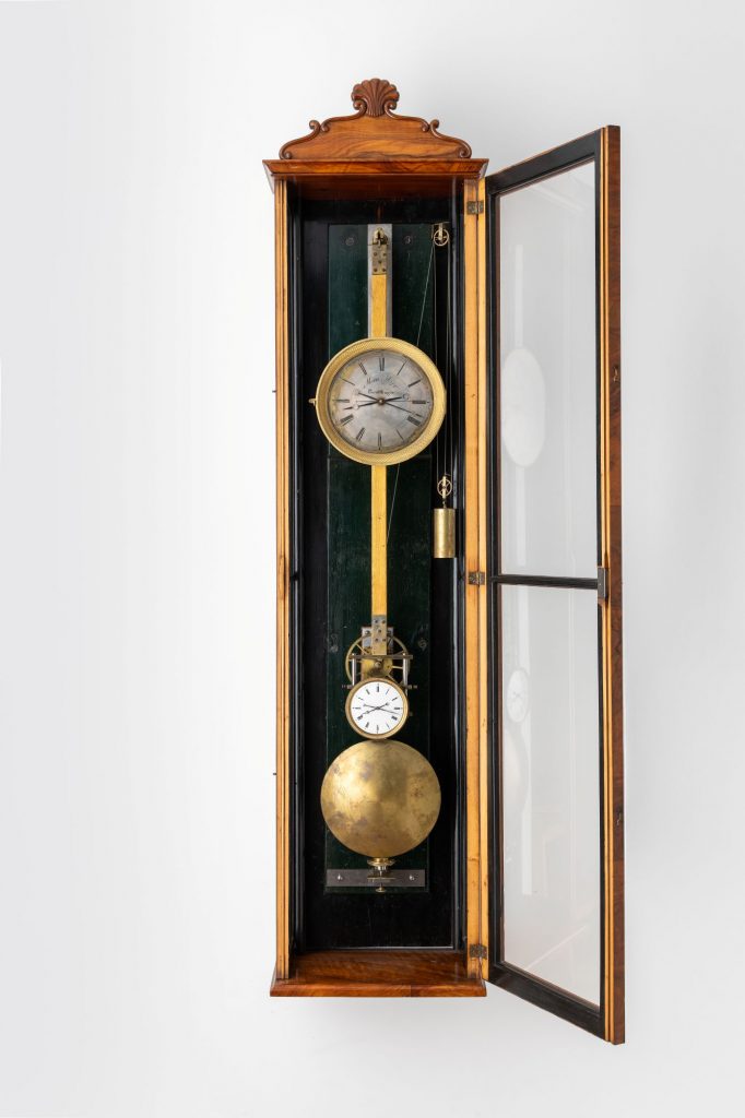 Weight-driven regulator with case opened to reveal pendulum and two dials