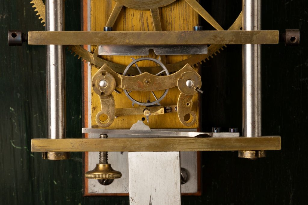 Close up of Hipp toggle prototype on mechanical weight-driven clock