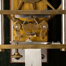 Close up of Hipp toggle prototype on mechanical weight-driven clock
